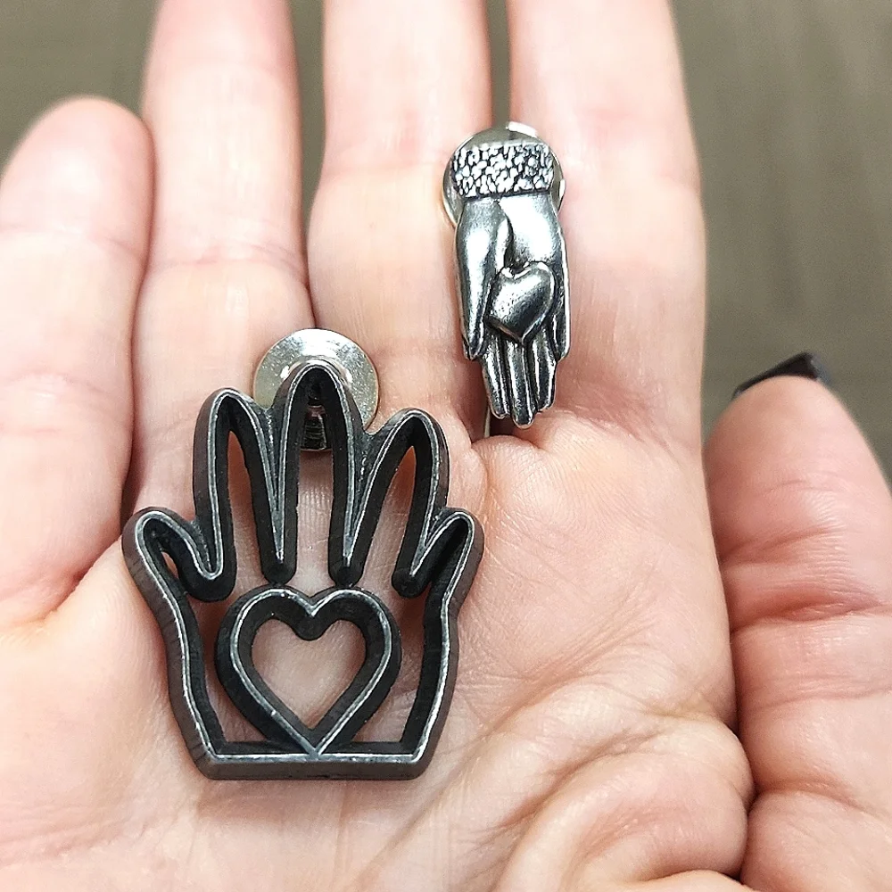 Pair Of Pewter Heart In Hand Clutch Pins